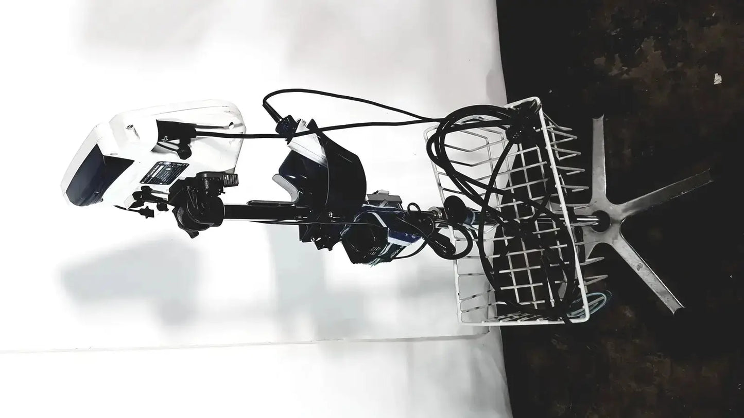 White and black electric outboard motor with attached basket shown alongside welch allyn glidescope cobalt avl monitor cart