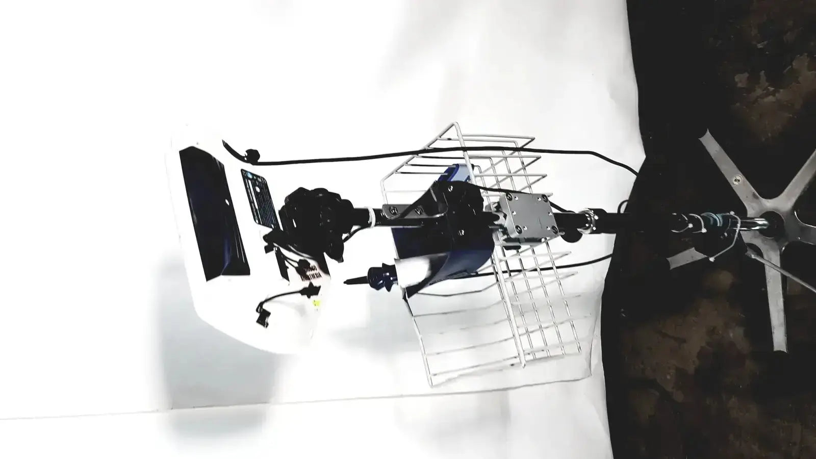 Back view of black and silver welch allyn glidescope cobalt avl monitor mounted on metal cage with cables and hardware