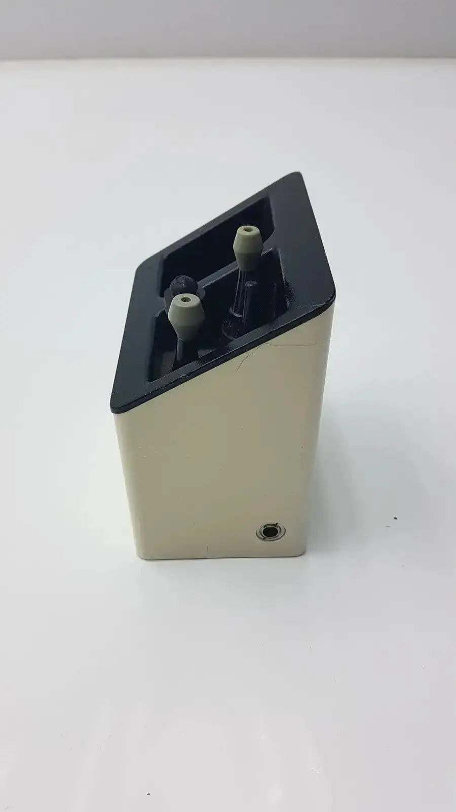 Beige and black rectangular welch allyn audio scope charging stand with two gray knobs used medical equipment for sale