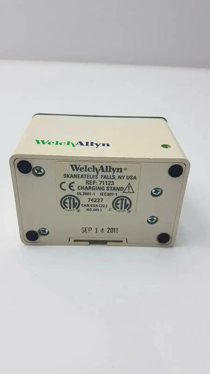 Beige welch allyn model 71123 charging stand with black corner feet and green indicator light used medical equipment for sale