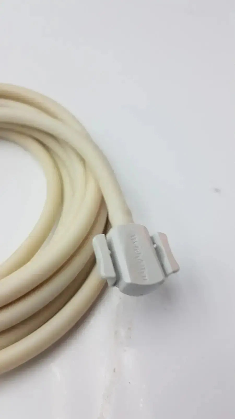 Beige coiled patient monitor cable with a gray plastic connector for Welch Allyn NBP patient monitor