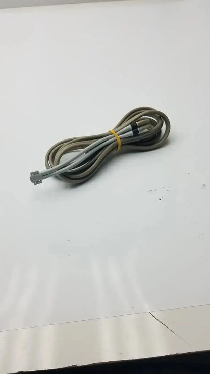 Coiled gray and white welch allyn double hose with yellow tie and rectangular connector for used medical equipment sale