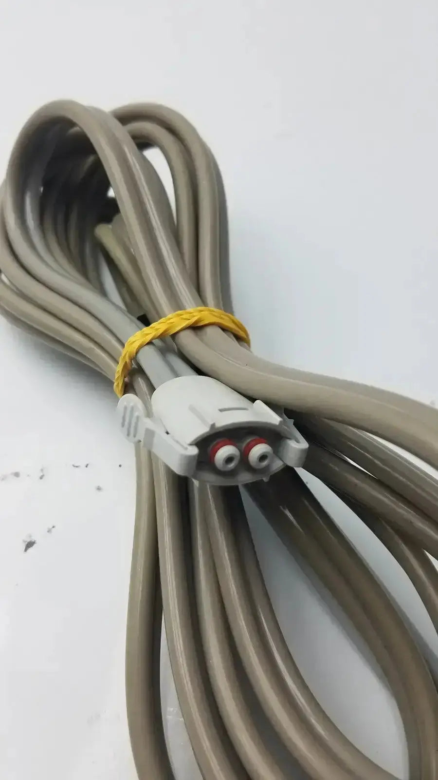 Coiled beige medical-grade double hose with white connector and red silver ports for welch allyn used medical equipment for sale
