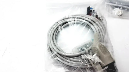 Gray coiled cable with beige connector and black plug packaged in clear plastic for welch allyn vital signs patient monitor