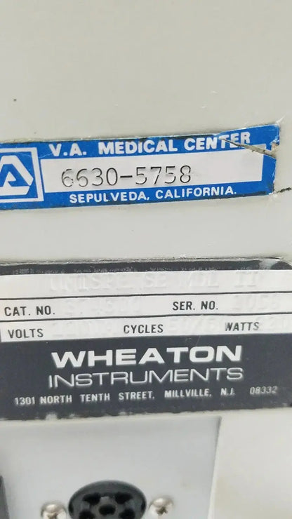 Wheaton instruments label in black and white on dark background showing wheaton unispense ii dose counter cat no 374300 g-bbdd4-14u