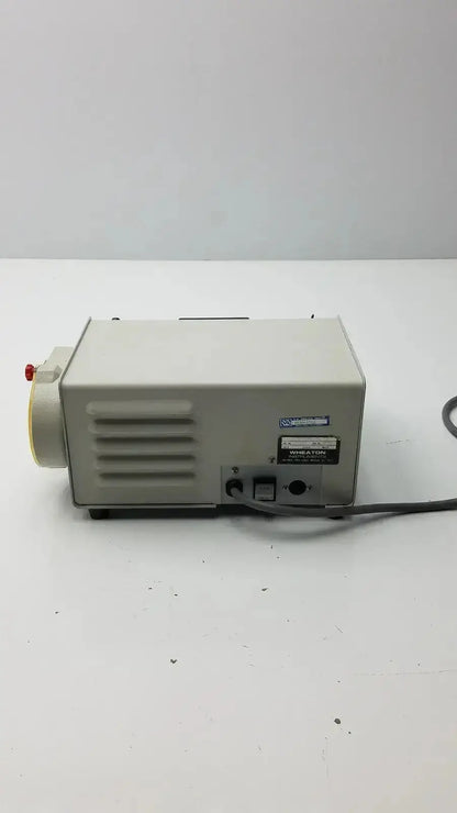Beige rectangular laboratory pump with red knob and black power cord wheaton unispense ii dose counter g-bbdd4-14u