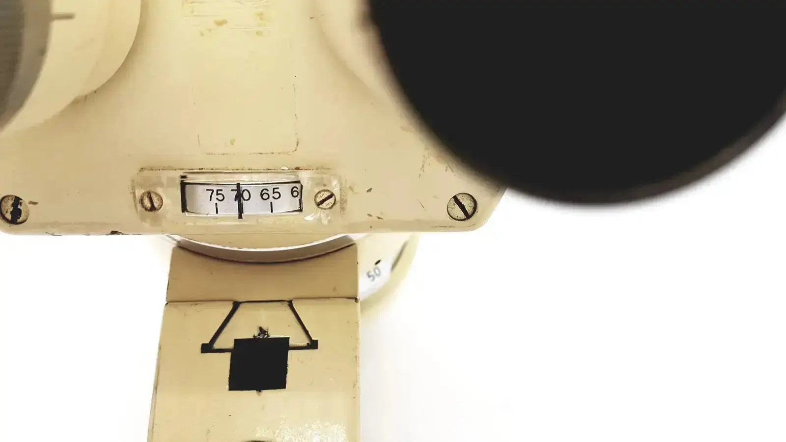 Cream-colored vintage-style optical dial with increments and screws on the wild heerbrugg m5-26436 microscope