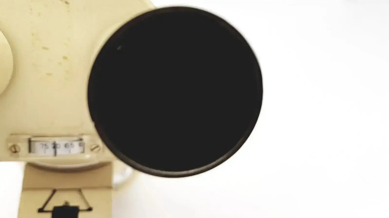 Cream-colored vintage Wild Heerbrugg M5-26436 microscope with a prominent black circular lens for precision viewing