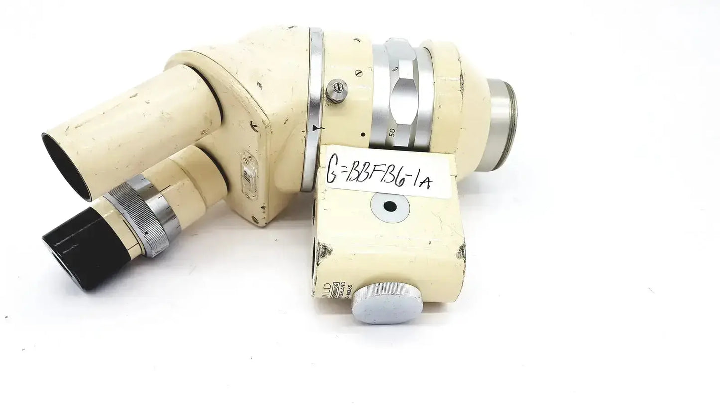 Cream-colored wild heerbrugg m5-26436 microscope with metallic silver accents and a handwritten label on the body