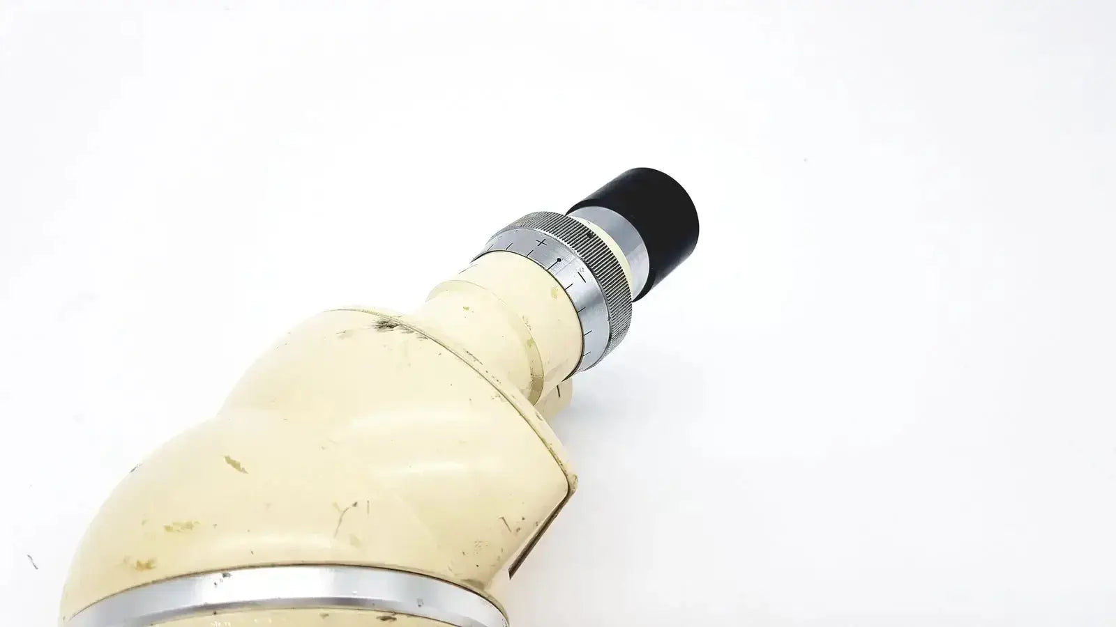 Cream-colored slightly worn Wild Heerbrugg M5-26436 microscope with black eyepiece and silver metallic rings