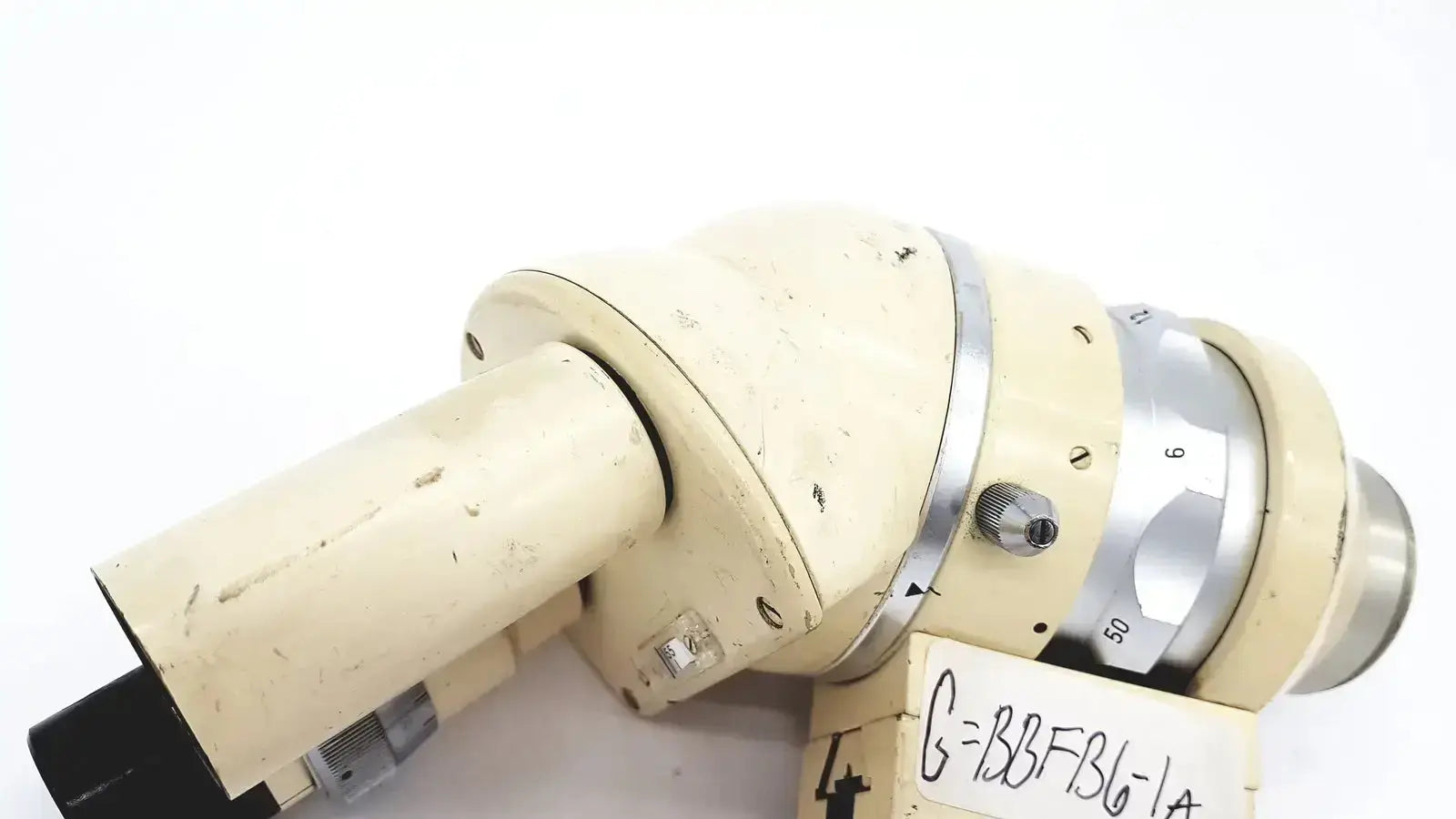 Cream-colored wild heerbrugg m5-26436 microscope with metallic focusing ring and black eyepiece showing slight wear