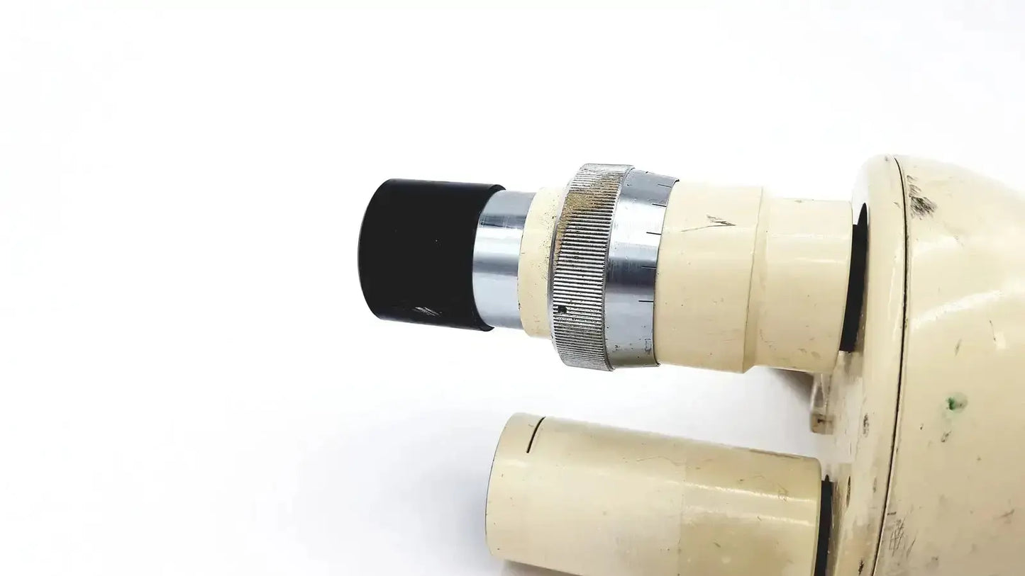 Cream-colored Wild Heerbrugg M5-26436 microscope with black eyepiece and silver metallic focusing ring