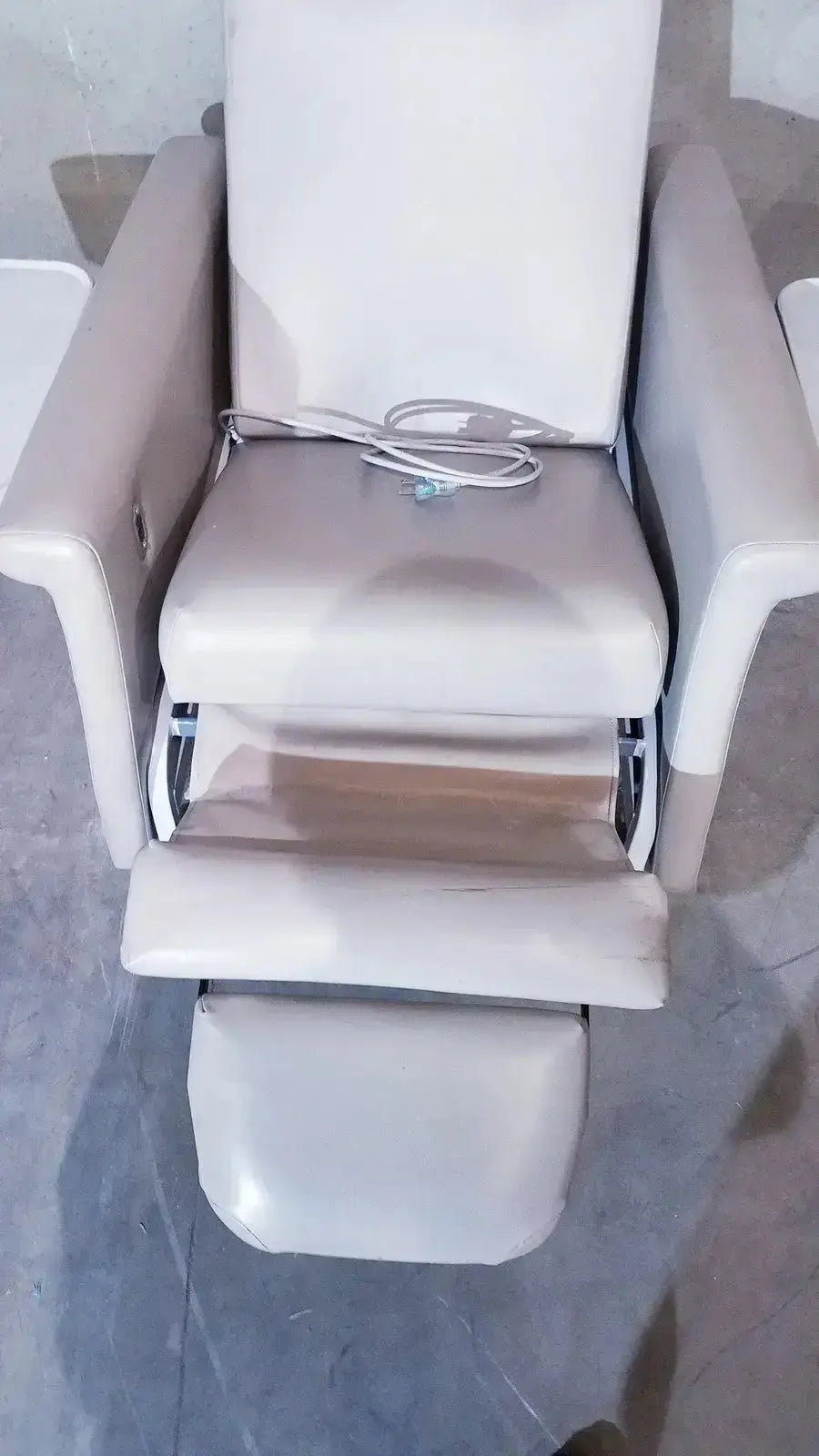 Beige leather winco 694 care recliner dialysis chair with adjustable footrest, armrests, back massager, and side trays