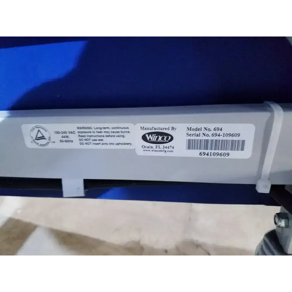Gray winco model 694 industrial heating element with serial number label on the back of a care recliner dialysis chair
