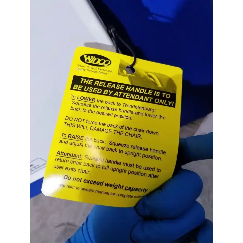 Yellow winco instruction tag for chair release handle on the back of care recliner dialysis chair with massager and trays