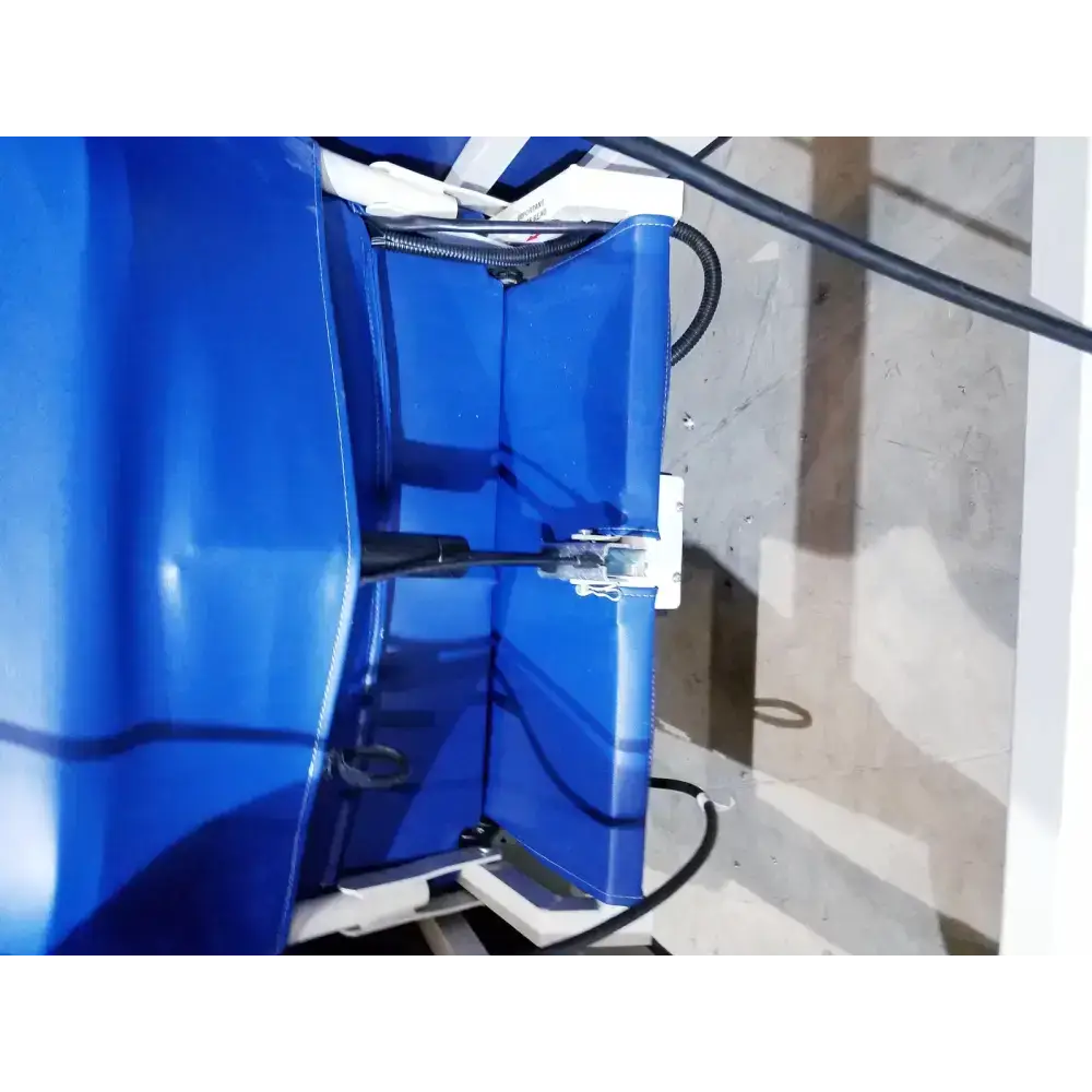 Blue plastic industrial component with white metal fittings and black cables on the back of winco 694 care recliner dialysis chair
