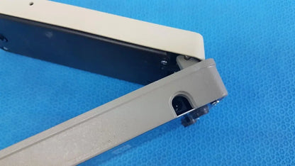 Beige and black plastic clamp with hinge mechanism on x-rite 331 battery operated transmission densitometer medical equipment