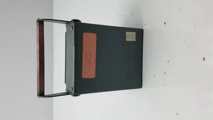 Dark green metal ysi model 42sc tele-thermometer with reddish-brown handle and two labels on the side