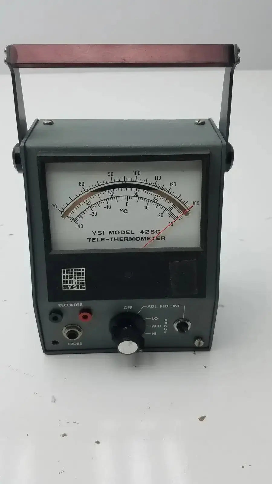 Dark green ysi model 42sc tele-thermometer with red handle and analog dial measuring temperature in degrees celsius