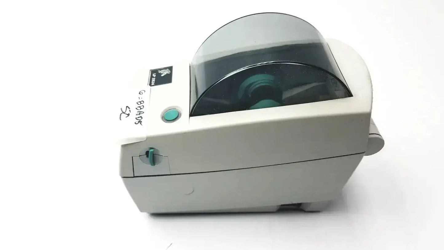 Gray zebra lp2824 thermal label printer with transparent protective cover over print mechanism for label printing