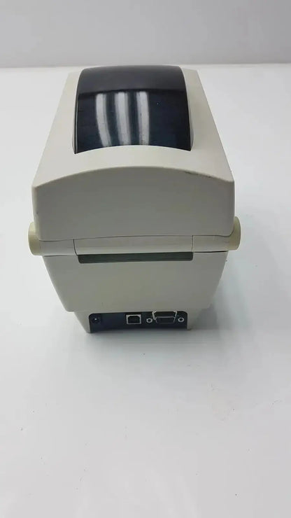 Beige zebra tlp 2824 plus thermal printer rear view with black top cover and visible ports for connectivity
