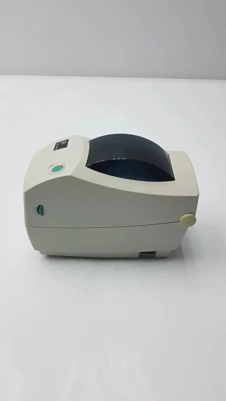 Beige zebra tlp 2824 plus thermal printer with black paper roll and green indicator lights for label printing