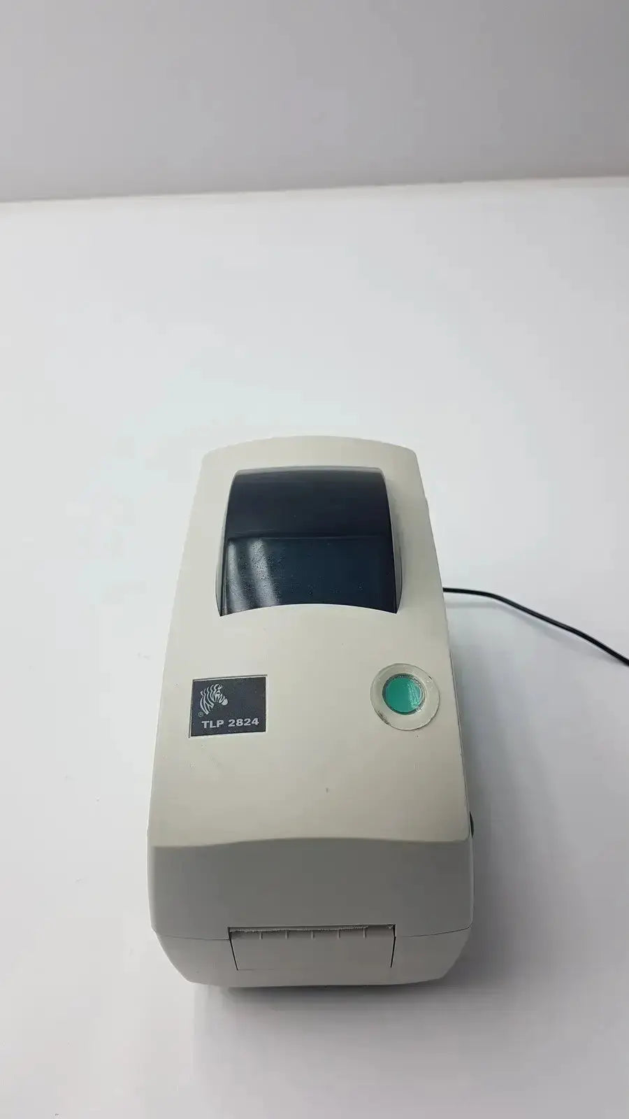 Beige zebra tlp 2844 plus thermal printer with green power button and black print window for label printing