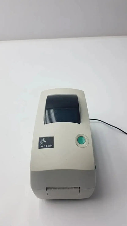 Beige zebra tlp 2844 plus thermal printer with green power button and black print window for label printing