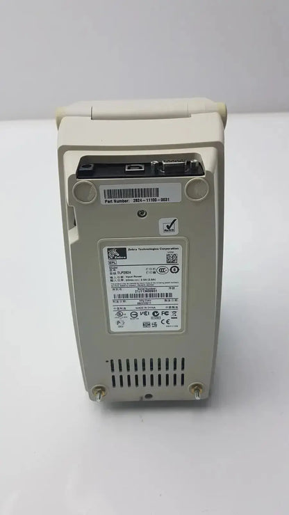 Beige zebra tlp 2824 plus thermal printer with compact rectangular design and ventilation slots at the bottom side