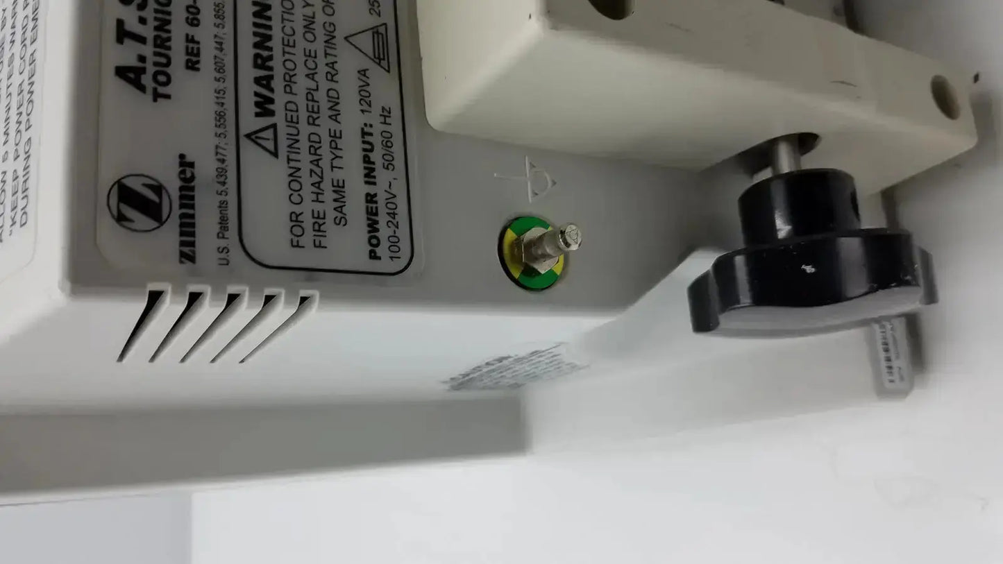 White plastic power supply unit with black rotary knob and green grounding screw for zimmer hall ats 3000 automatic tourniquet
