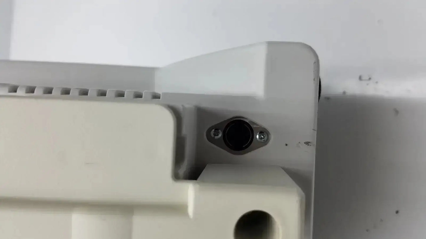Off-white plastic housing with black circular port secured by screws on back side of zimmer hall ats 3000 automatic tourniquet