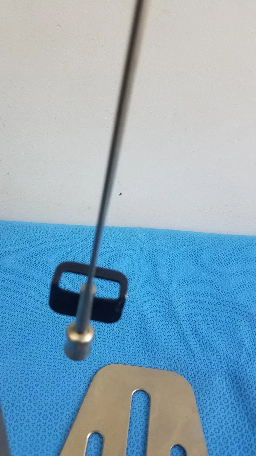 A sleek metallic antenna with black rectangular base and gold-toned connector for biomet finneli tensioning medical equipment