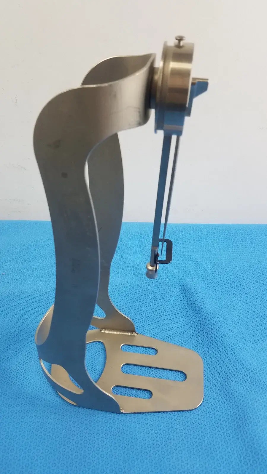 Zimmer Orthopedic Biomet Finneli tensioning boot medical equipment with sleek metallic base and brass gear assembly for reuse medical equipment