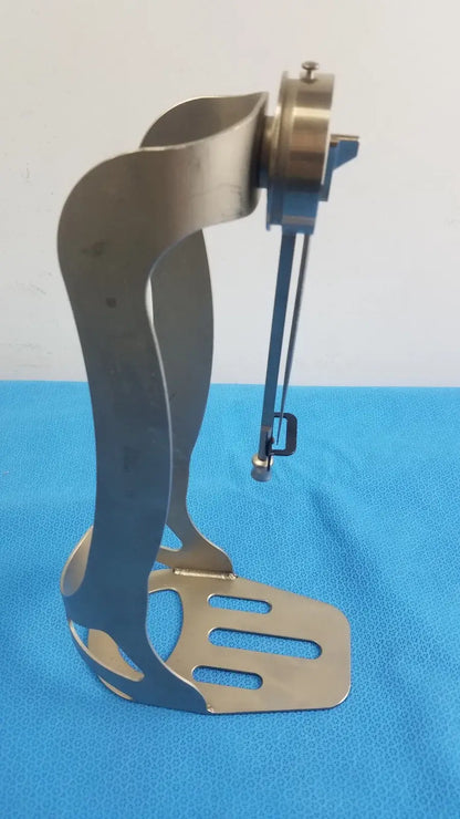 Zimmer Orthopedic Biomet Finneli tensioning boot medical equipment with sleek metallic base and brass gear assembly for reuse medical equipment
