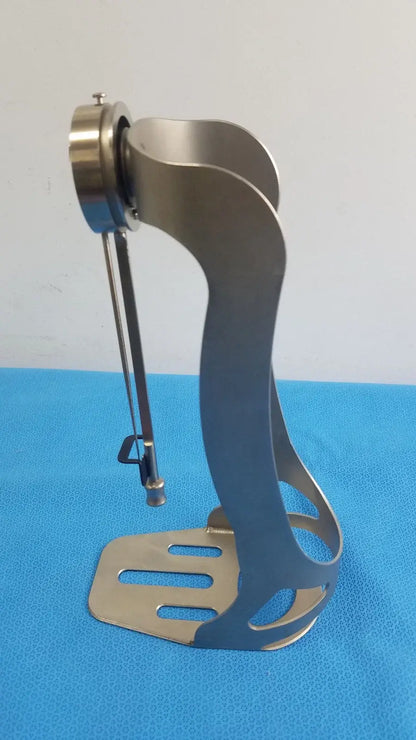 Stainless steel Zimmer orthopedic Biomet Finneli tensioning boot stand with curved openwork design and circular top mount