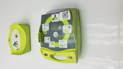 Lime green zoll aed plus automated external defibrillator with instructional stickers and handle for emergency use