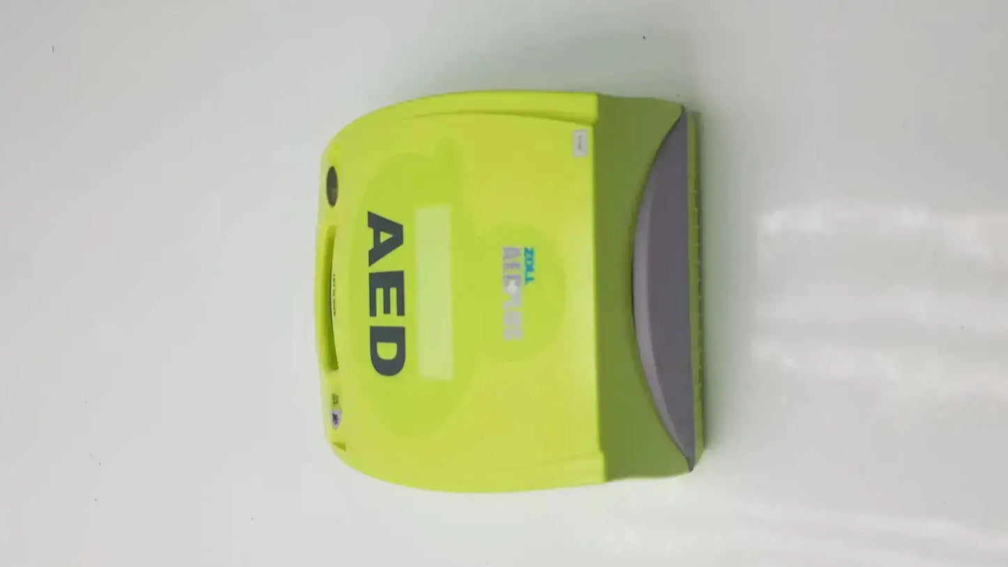 Bright lime green zoll aed plus defibrillator with gray accent designed for emergency cardiac use