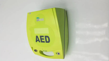 Bright lime green zoll aed plus defibrillator with bold black lettering and sleek compact design for emergency use