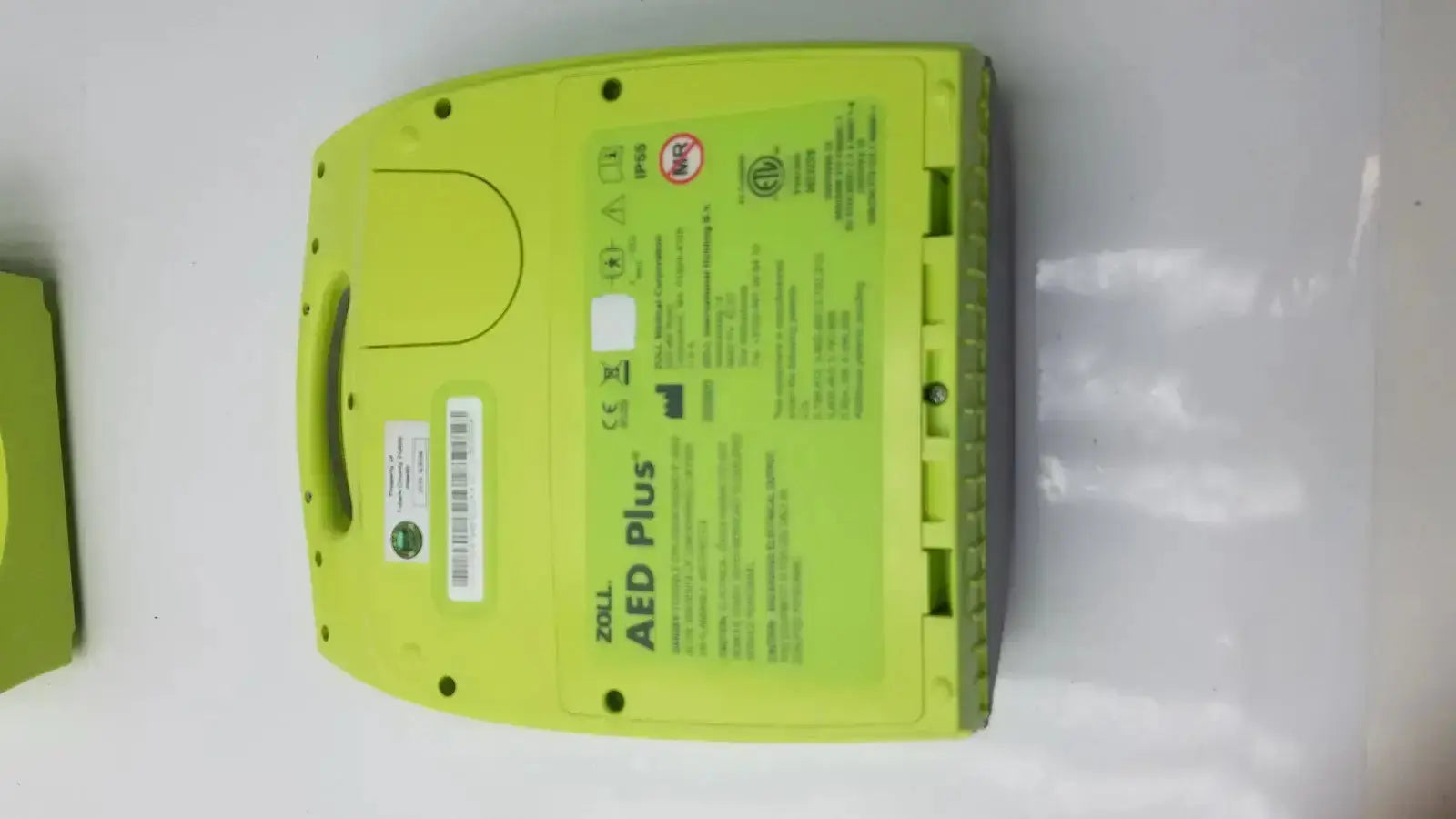 Bright lime green zoll aed plus automated external defibrillator case with molded plastic housing and built-in handle