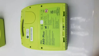 Bright lime green zoll aed plus automated external defibrillator case with molded plastic housing and built-in handle