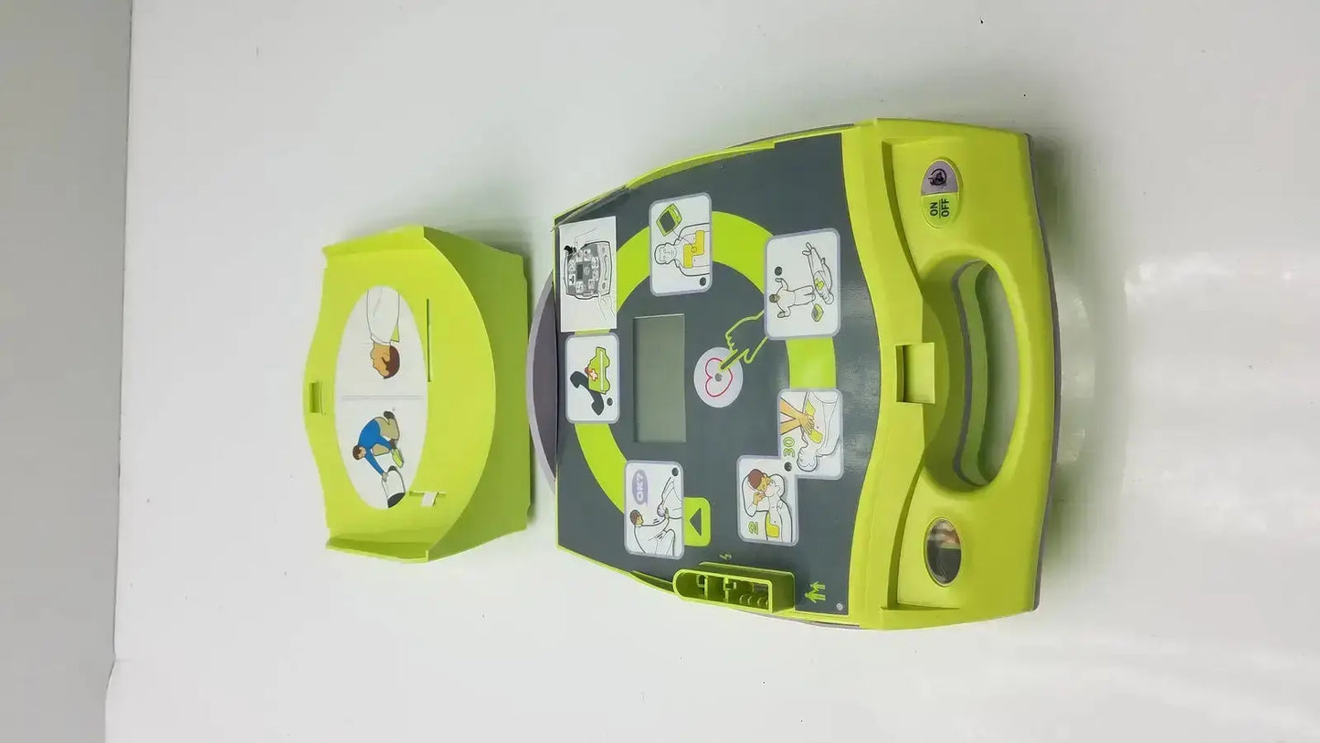 Lime green and dark gray zoll aed plus defibrillator with instructional diagrams for emergency cardiac use