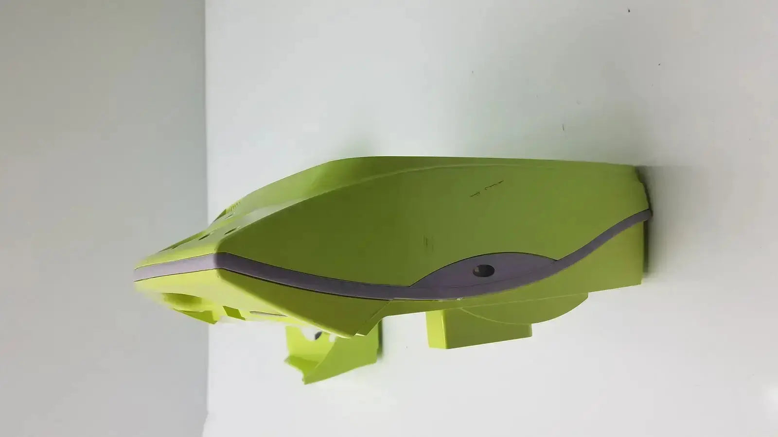 A lime green plastic model of the futuristic front section of the zoll aed plus defibrillator with gray accents