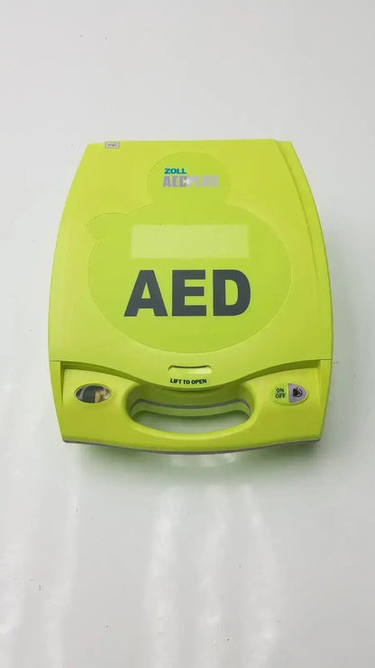 Bright lime green zoll aed plus defibrillator with ergonomic design and prominent black lettering for emergency use