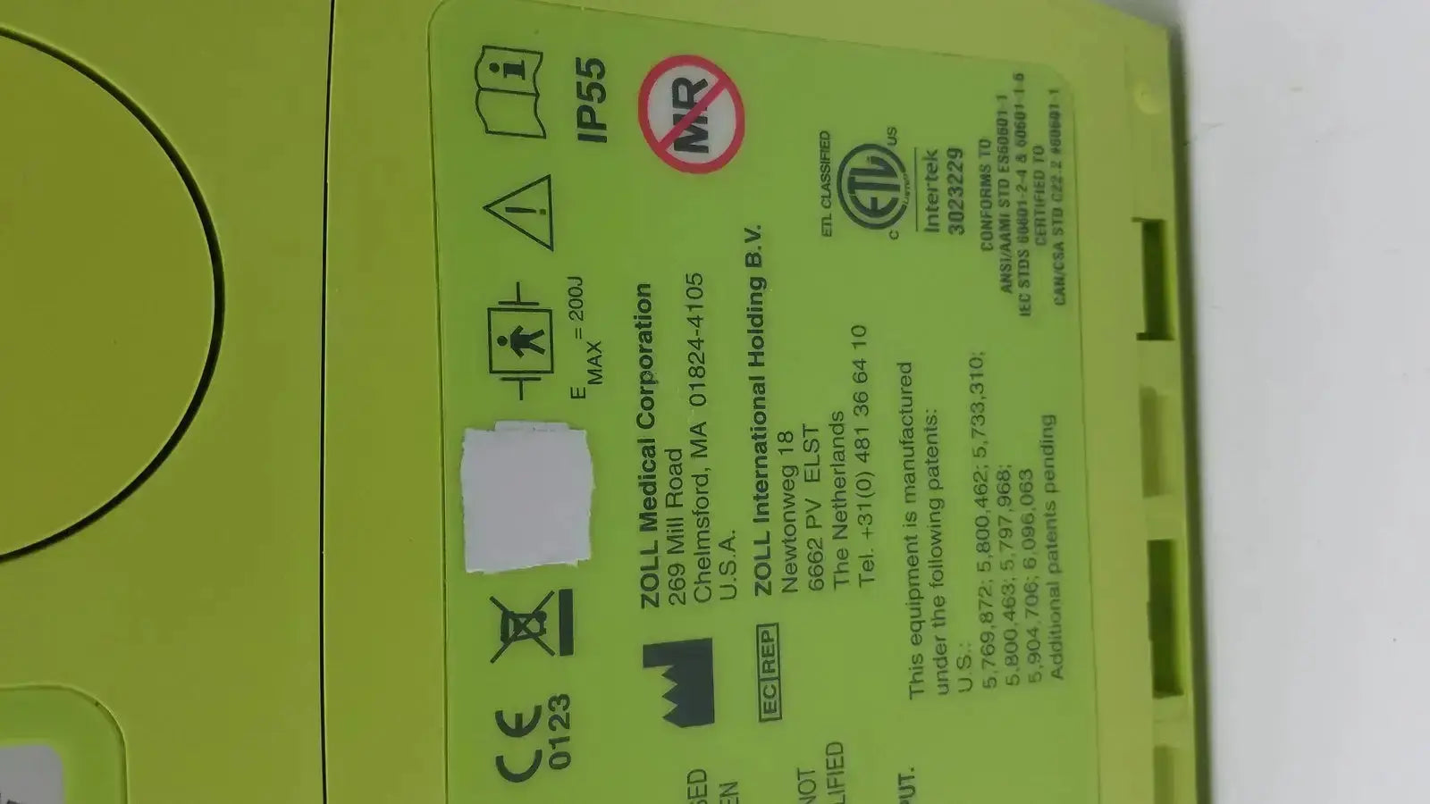 Lime green plastic medical device case with manufacturer and safety labels for zoll aed plus defibrillator product