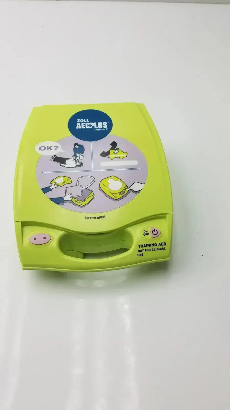 Lime green zoll aed plus trainer 2 with illustrated step-by-step instructions and portable handle for easy training use